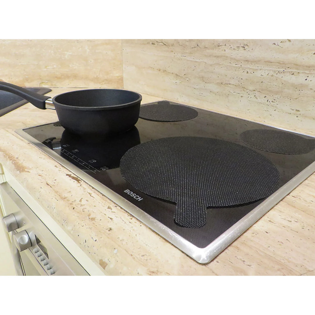 NoStik gray 27 cm induction hob protector under a pan on an induction cooktop